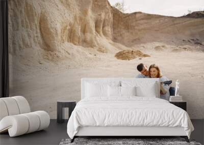 Young couple in love in sand career Wall mural