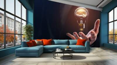 Businessman holding a bright light bulb. Concept of Ideas for presenting new ideas Great inspiration and innovation new beginning Wall mural