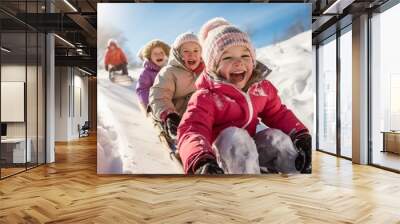 Happe Children sledding down a snowy hill. Winter vacation concept Wall mural