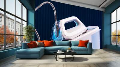 White steam generator iron on a blue background Wall mural