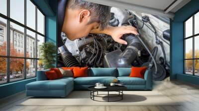 Asia car mechanic working in auto repair service Wall mural