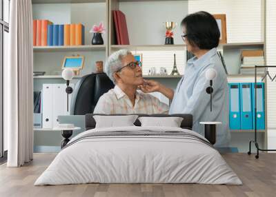 Happy senior Asian couple using a laptop at home for find new tourist attractions together. Happy retirement with planning, saving, pension And the good capital uncle of the elderly Wall mural