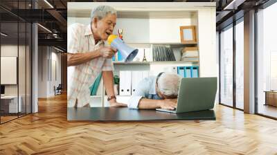 Old Asian elderly yell to a megaphone to talk with a friend for communication. Concept of communication problem in aging cause of ear be without hearing, deaf Wall mural