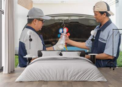 two Auto repairman checks the engine and cooling system before traveling on a long holiday. Concept of Car care and maintenance from experts, Coaching, and advice For practicing a car from an expert Wall mural