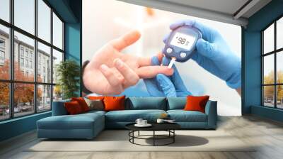 Doctor checking blood sugar level with glucometer Wall mural