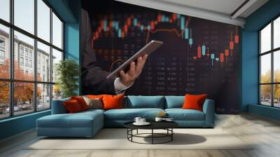 Investor with tablet, stock market background Wall mural