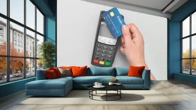 Man using credit card and payment terminal Wall mural