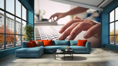 Man using laptop at home, typing hands Wall mural