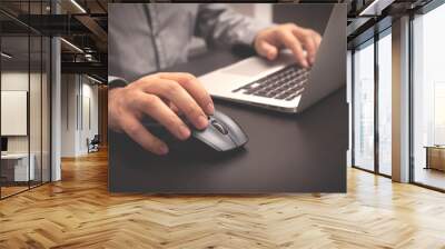 Man working with laptop in office Wall mural