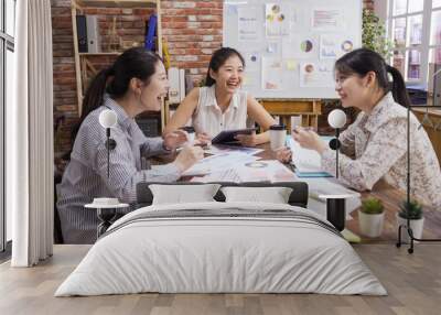 Group of contemporary business female people working in meeting room. three asian chinese lady coworkers laughing cheerful during project discussion in vintage bright office. woman sharing ideas. Wall mural