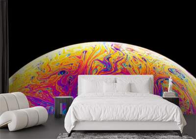 Rainbow soap bubble on a dark background. Close-up of colorful surface. Wall mural