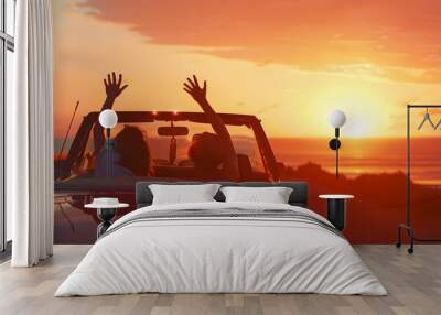 Two people in a car celebrating, with a sunset background, embodying the concept of freedom and travel Wall mural