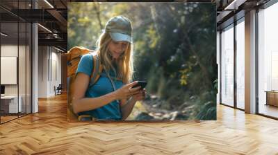 Young Woman Hiker Using Mobile Phone in Forest Wall mural