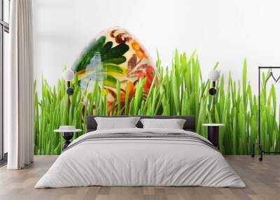 Easter egg in the grass isolated on white Wall mural