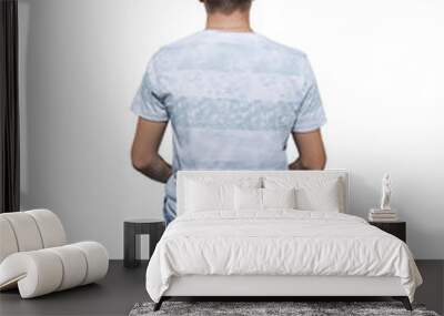 Rear view full length portrait of pensive young man sitting on a old chair and meditate isolated over white background. Wall mural