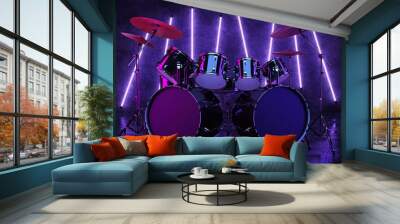 The drum kit is located in a dark room and is illuminated by neon lamps that hang on the wall. A cyberpunk-style drum kit, illuminated by neon light and reflected on the glossy floor. 3D Render. Wall mural