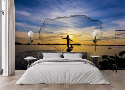 fishermen throwing net fishing in lake on morning sunrise Wall mural