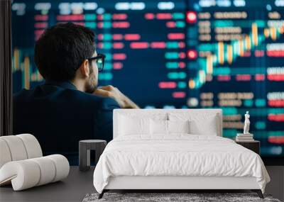 Businessman analyzing stock market trends on a digital screen for investment strategies and market insights. Wall mural