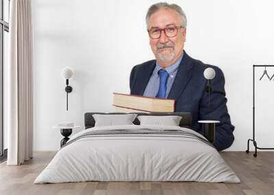 Senior teacher standing holding a book, with suit with necktie. Wall mural