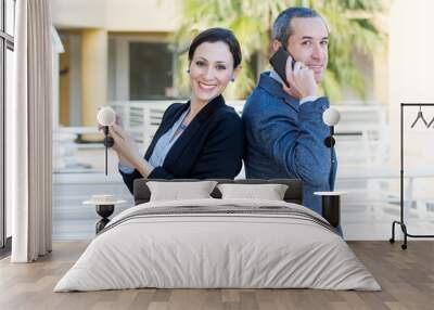 Successful business couple teamwork with smartphone, outside off Wall mural