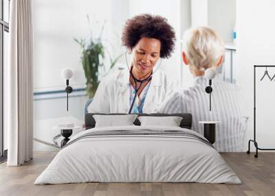 Doctor measure blood pressure in ambulance older woman Wall mural