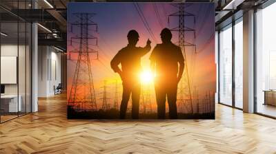 Silhouette Teams engineer looking High voltage electric tower on sunset time and sky on sunset time  Wall mural