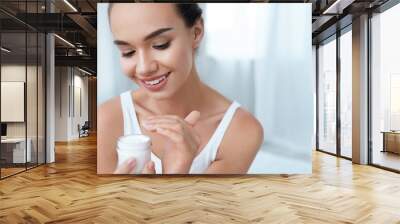 Beauty Skin Care. Beautiful Woman Applying Cream On Face Skin Wall mural