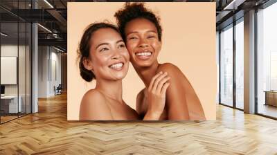 Beauty. Smiling women with perfect face skin and natural makeup portrait. Beautiful happy asian and african girl models with different types of skin on beige background. Spa skin care concept Wall mural