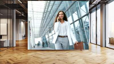 business woman with phone near office Wall mural