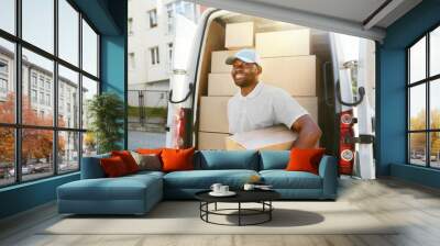 Courier Delivery Service. Man With Package Near Car With Boxes Wall mural