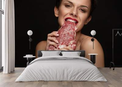 Eating Meat. Beautiful Woman Biting Raw Red Beef Steak Meat Wall mural