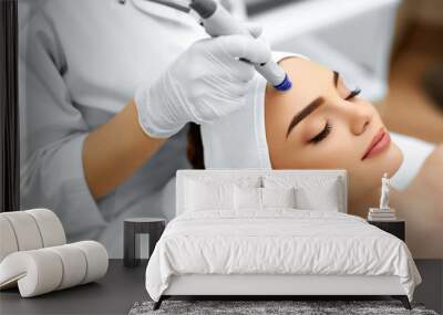 Face Skin Care. Close-up Of Woman Getting Facial Hydro Microdermabrasion Peeling Treatment At Cosmetic Beauty Spa Clinic. Hydra Vacuum Cleaner. Exfoliation, Rejuvenation And Hydratation. Cosmetology.  Wall mural