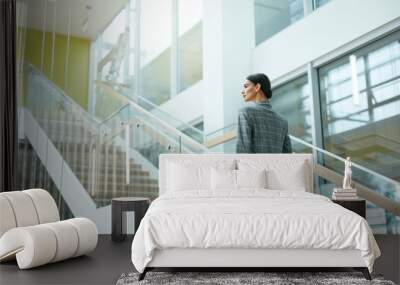 Female Worker On Stairs In Office Indoors Wall mural