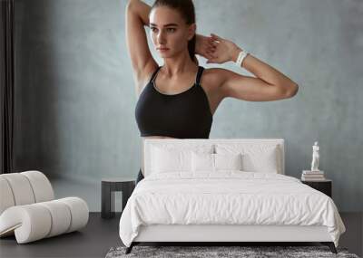 Fitness Woman Stretching Arms In Stylish Black Sport Clothes Wall mural