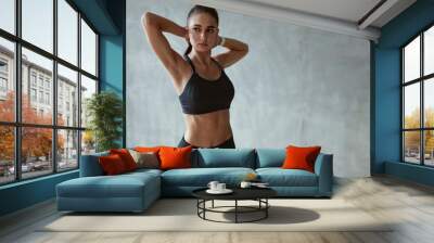 Fitness Woman Stretching Arms In Stylish Black Sport Clothes Wall mural