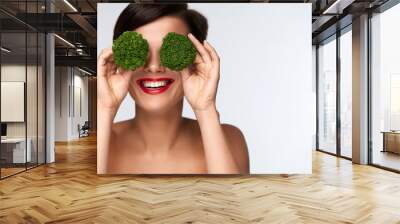 Food For Health. Beautiful Woman Holding Broccoli Before Eyes Wall mural