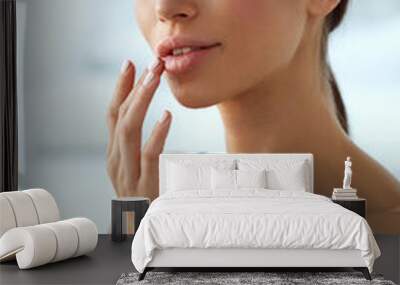 Lips Skin Care. Woman With Beauty Face Applying Lip Balm On Wall mural