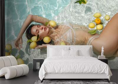 Model Floating With Citrus. Beautiful Girl In Bikini Swimming In Pool At Tropical SPA. Wall mural