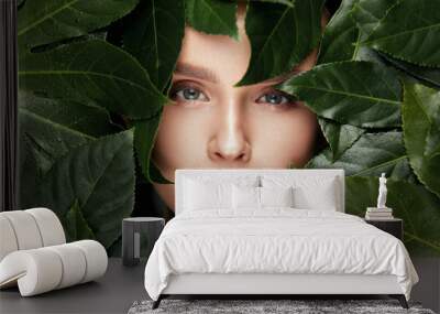 Natural Beauty. Beautiful Woman Face In Green Leaves. Wall mural