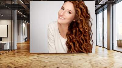 red hair. woman with beautiful curly hair Wall mural