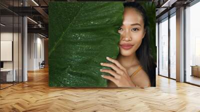 Skin care. Woman model with beauty face and natural green plant Wall mural