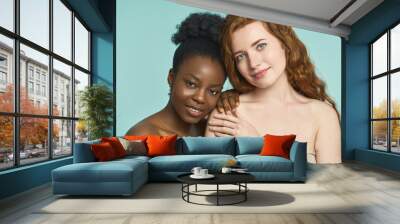 Two Diverse Women Embracing, Looking At Camera Wall mural