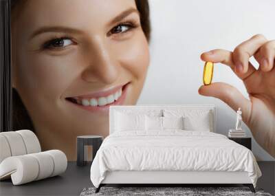 Vitamins. Healthy Eating. Happy  Girl With Omega-3 Fish Oil Capsule. Healthy Diet Concept. Wall mural