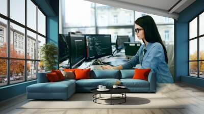 Young Woman Working And Programming On Computer In Office. Wall mural