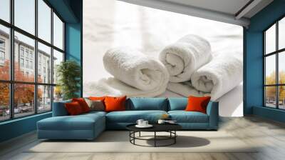 Close-up of a rolled white bath towels on a white background. Wall mural