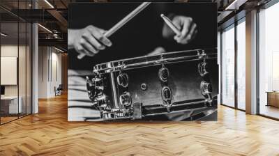 Close-up shot of a drummer playing a snare drum with sticks. Wall mural