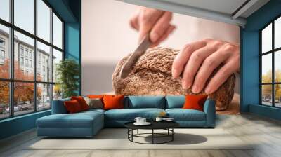 fresh bread in hands closeup on old wooden background Wall mural