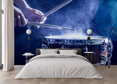 man plays musical percussion instrument with sticks, a musical concept, beautiful lighting on the st Wall mural