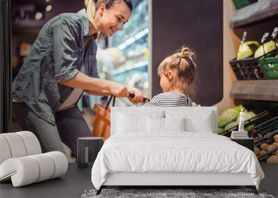 Mom and daughter are shopping at the supermarket Wall mural