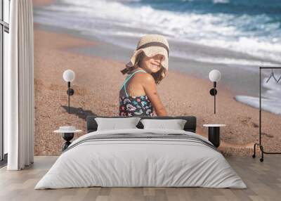 Portrait of a cheerful little girl in a bathing suit by the sea Wall mural